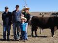 Guilford Poll Hereford farm hand Jack Davie, Ouse, Tasmania, with buyers of the top-priced bull, Jamie and Rebecca Woolley, Bermuda Hills, Glen Huon, and their son Max (five) and daughter Violet (18 months). Picture by Barry Murphy