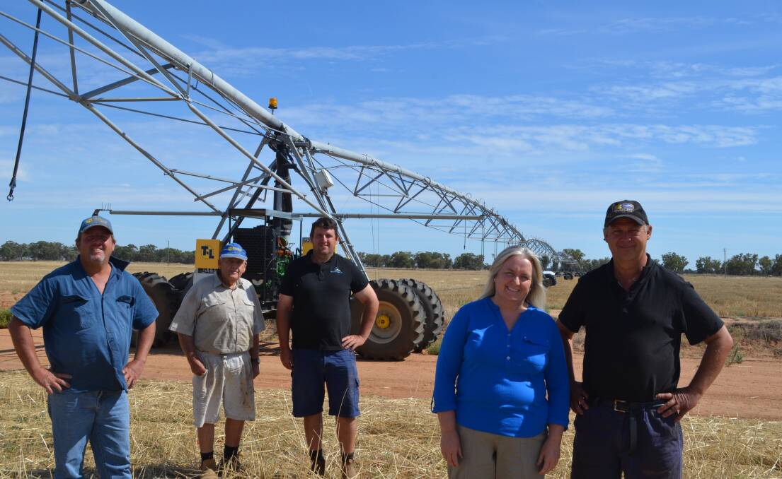 Angus, Alastair, Bruce, Karen and Graeme Macdonald under one of the lateral moves on their irrigation aggregation near Blighty, in the southern Riverina. 
