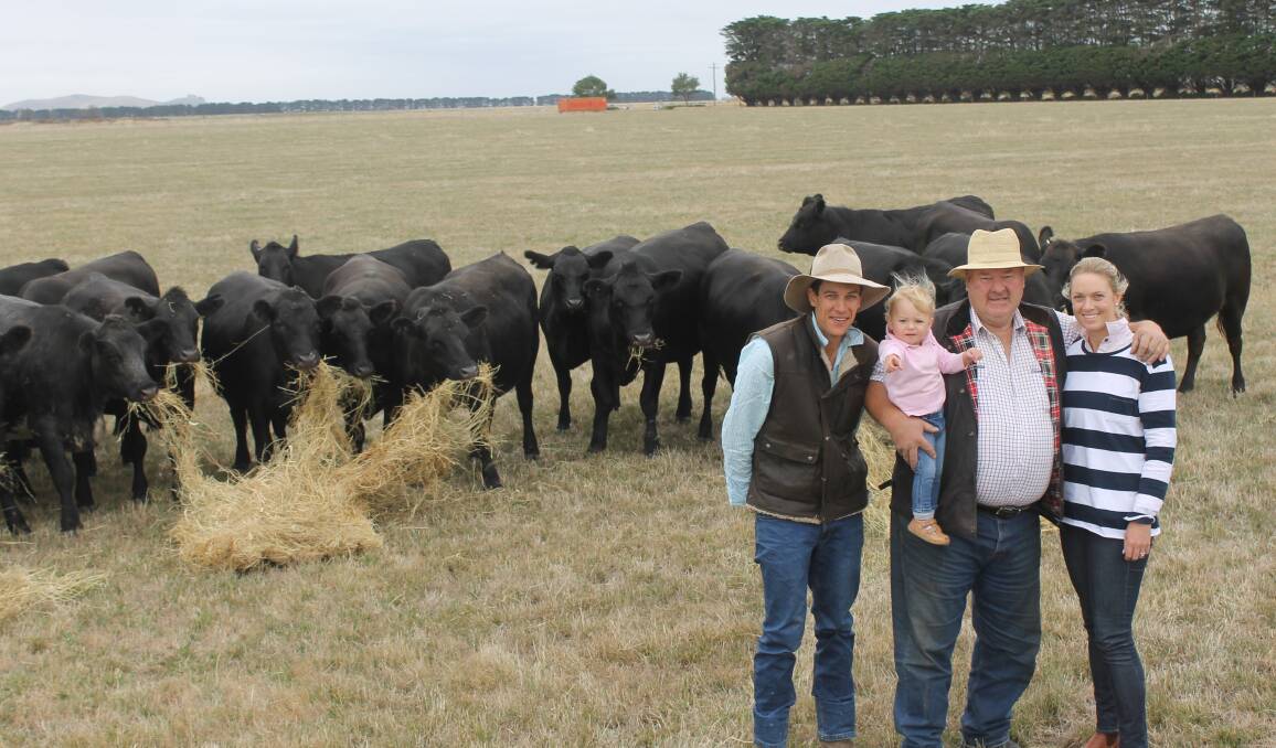 Three generations in the beef industry. James Knight, with his daughter, Olivia, father-in-law, Bruce Allen and wife Georgie, with a draft of their Angus females at Mortlake, Victoria. Photo by Laura Griffin.