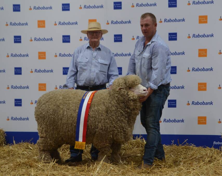 John Williams, Thalabah stud, Laggan with his four-tooth fine/medium wool grand champion Merino ewe and Anthony Frost