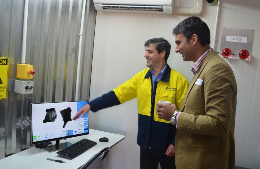 Paul Danelutti, Scott Automation and Robotics, Rydalmere, and Dr Peter McGilchrist, Murdoch University, Perth, look at the image of a beef carcase on the new dual x-ray absorptiometry system, showcased at Jindalee Feedlot.