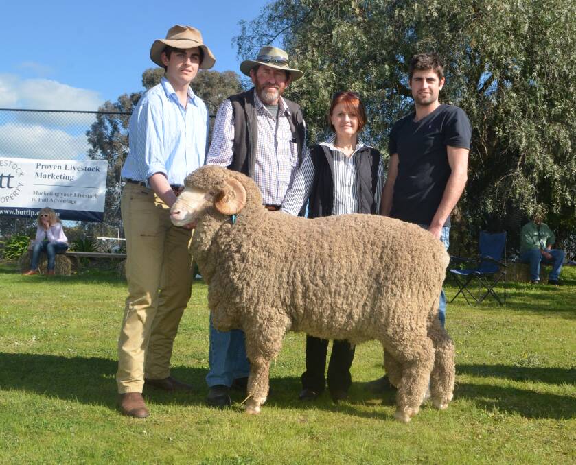 Sam Phillips, Yarrawonga, with Bill, Brent and Margaret Mackay, Yass, with the top priced Merino ram they bought for $16,000.