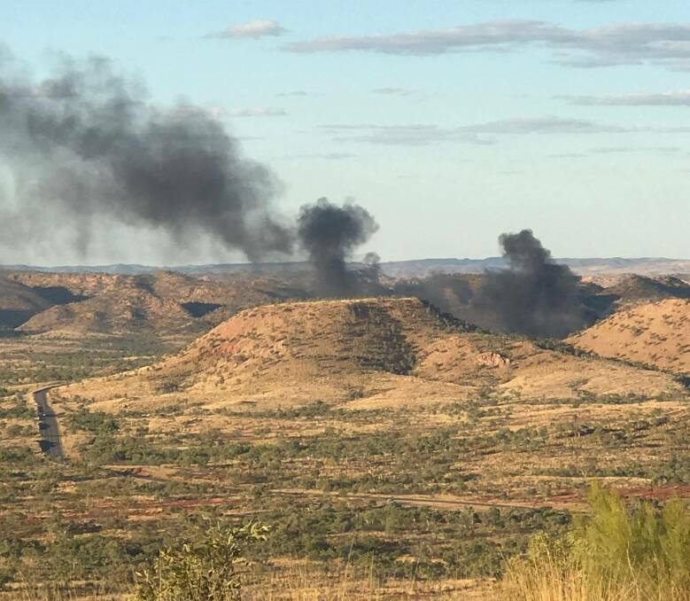 The smoke from the fire caused by the cattle road train that crashed. The photo was taken from Telstra Hill, east of Mount Isa. Photo: Jair Harney. 