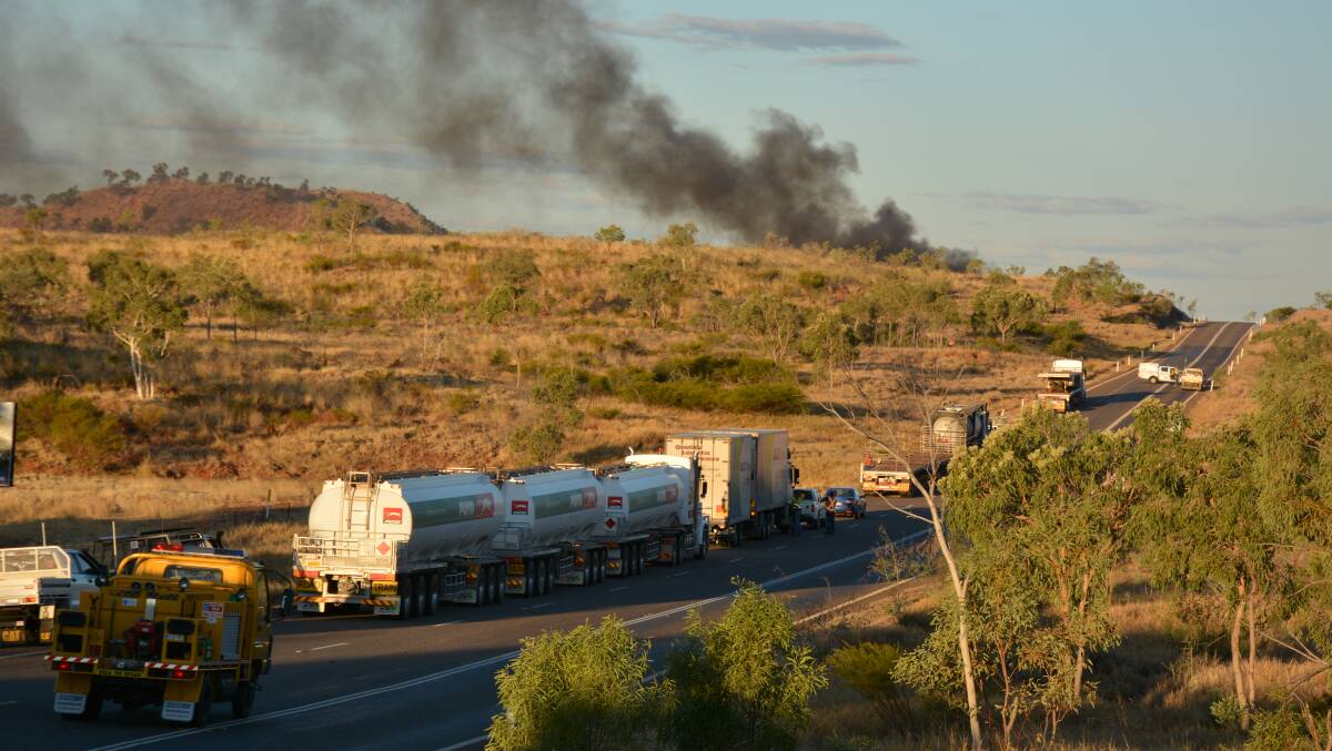 ON THE HIGHWAY: Smoke from the road train which is carrying cattle about 12 kilometres east of Mount Isa. The Barkly Highway was closed overnight. Photo: Chris Burns. 