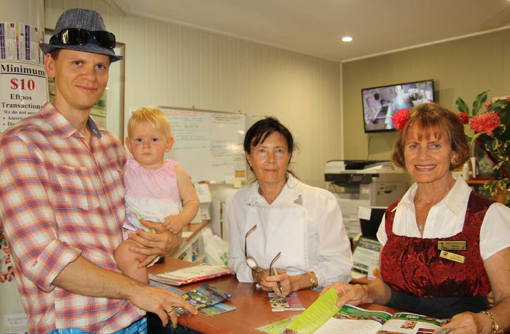 Sydney visitors Igor Katel and Angelika Katel, 1, sign in with volunteers Jan Byrne and Millie Cek at heritage centre.