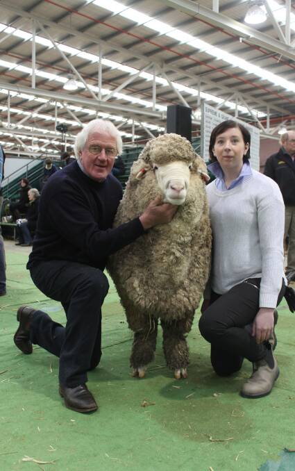 John and Nicole Crawford with the grand champion Poll Merino ram, whose wool measured 17.2M, 2.5SD, 14.5CV and 99.9 per cent CF.