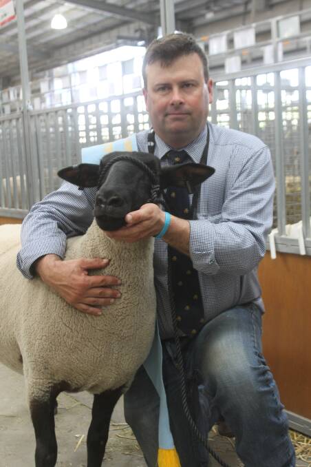 Alastair Day with the Allendale supreme Suffolk exhibit-winning ewe.