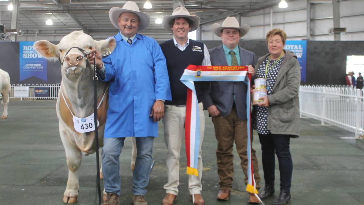Warren Miller leads the grand champion Charolais bull. He is with sponsor Rob Abbott, Mount William Charolais stud, judge Geordie Elliot, and owner Ann-Marie Collins.