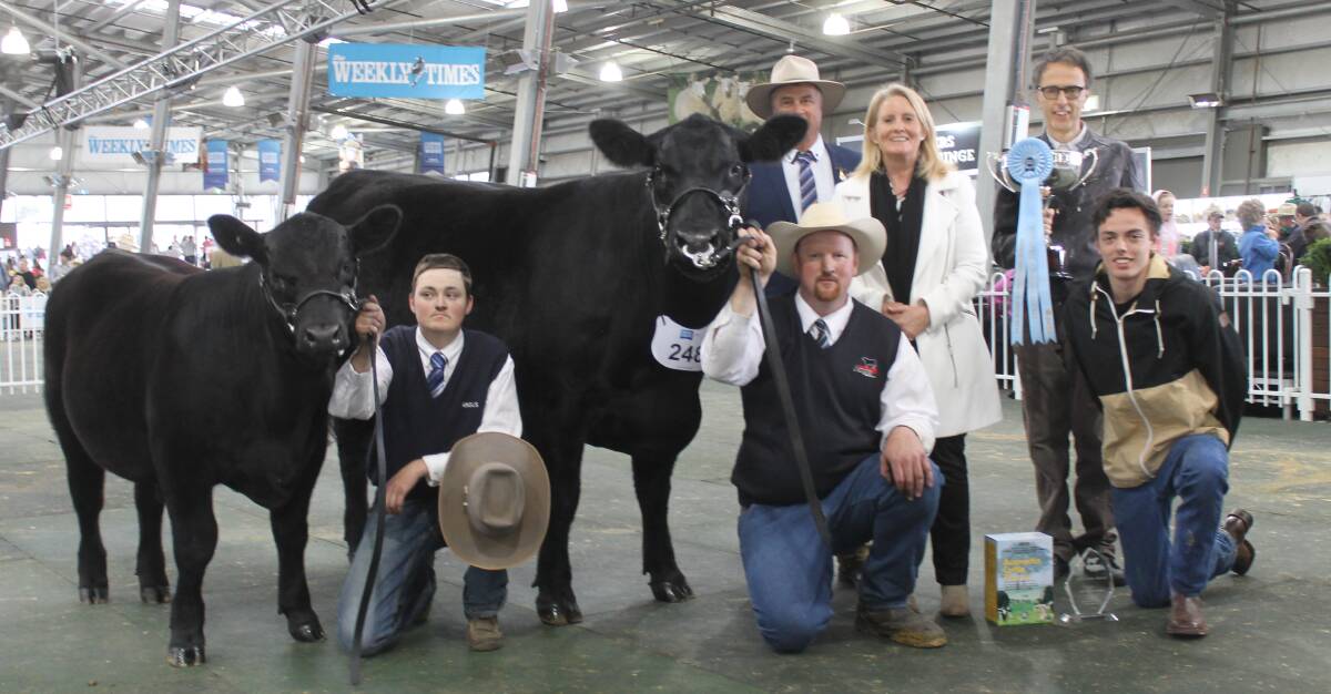 Lane Evans (left) and Tim Lord led KO Angus' supreme winning cow, judged by Brent Fisher, NZ, sashed by his wife Anna, and with principal Theo Onisforou and son Angus.