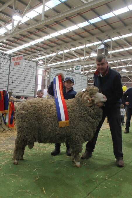 Paddy, 11, and Garry Cox with the Langdene grand champion fine ram.