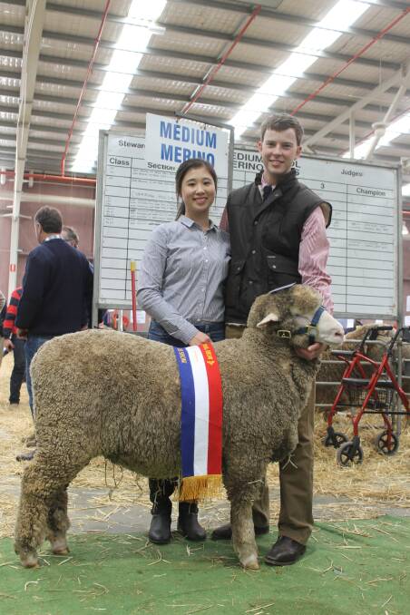Heidy Cai, financee to Angus Heath, grandson of Ross Wells, Willandra Merinos, with the grand champion medium ewe.