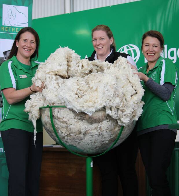 Charity auction: Carlie Ryan and Kristy Cook, both of the OTIS Foundation, flank Australian Fleece Competition convener Candice Cordy, Landmark. Photo: Laura Griffin