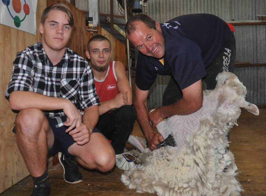 INDUSTRY MENTOR: Max Hayes, Warrimoo, NSW, and Hoby Lambert, Mount Gambier, with Shannon Warnest at the tafeSA shearer and wool handler course.