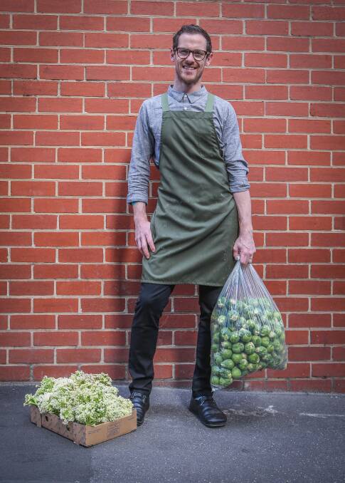 Chef Nate Wilkins with vegetables he uses in the popular vegetarian dishes at Higher Ground restaurant in Melbourne’s central business district.