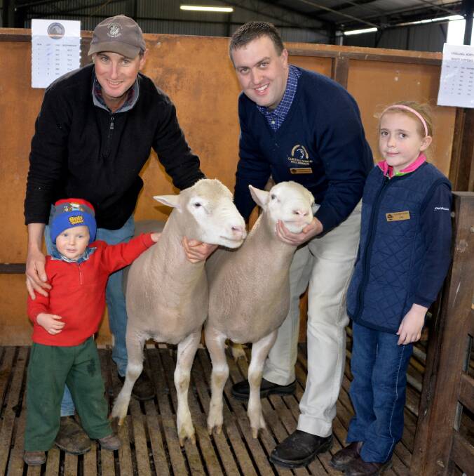 Pictured with the two $850 top priced Select Poll Dorset rams in the stud’s 60th year are purchaser Darren Schmidt, with son Jed, Lameroo and stud co-principal Grant Johnson with daughter Elsie.