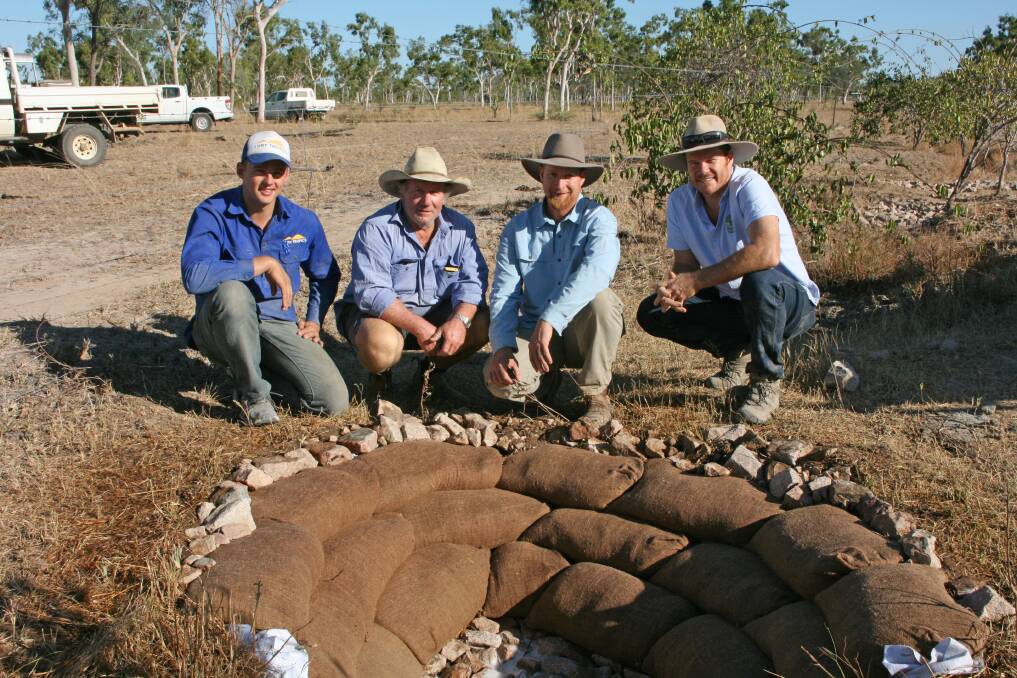 Jared Sunderland NQ Dry Tropics, Dave Roberts Swans Lagoon, Craig Sponholtz Watershed Artisans USA and Kim Kruse, RegenAG surround the Zuni bowl installed at Swans Lagoon in 2015 during a major gully regeneration project.