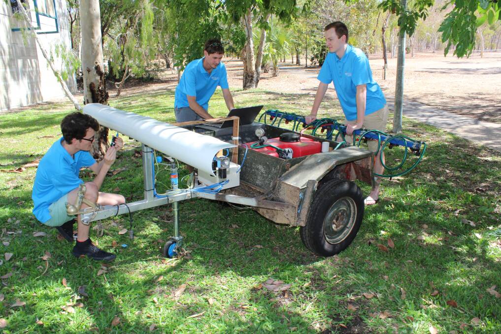 James Cook University Engineering and Related Technologies PhD student Alex Olsen (right) working on the robotic weed killer with project teammates Jake Wood and Brendan Calvert.