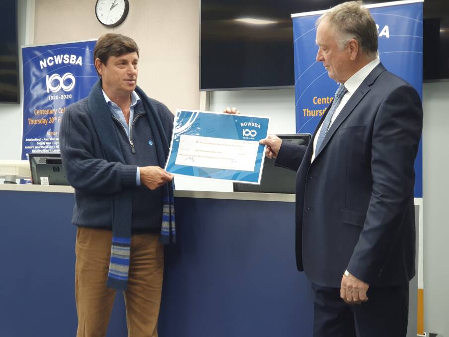 CHEQUE PRESENTATION: NCWBA president John Colley, presented a cheque for $8,000 to the Michael Manion Wool Industry Foundation chairman Ken Stock, at the Melbourne Wool Selling Centre. 