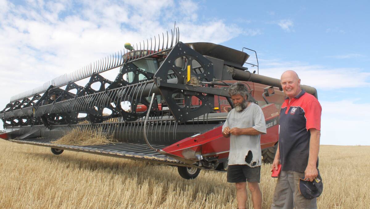 SIMPLE SYSTEM: Header driver Tim Sharp (left) examines the harvest, with Pine View, Tempy, owner Mike Robertson. 