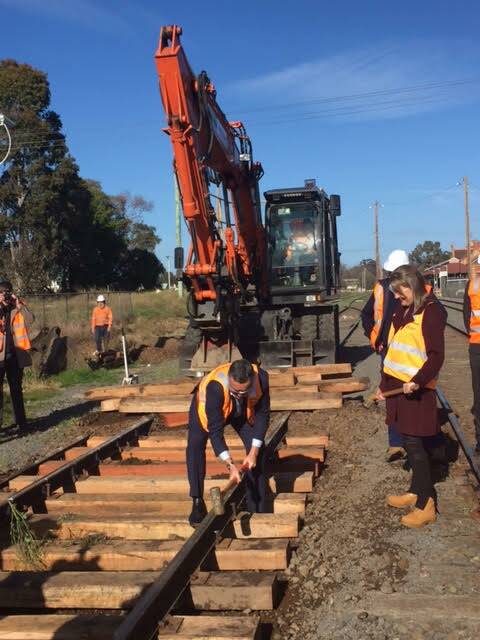 FREIGHT FUTURE: Federal Transport minister Darren Chester drives a spike into a sleeper, as part of the second stage of the Murray Basin rail project, watched on by Victorian Public Transport minister Jacinta Allen.