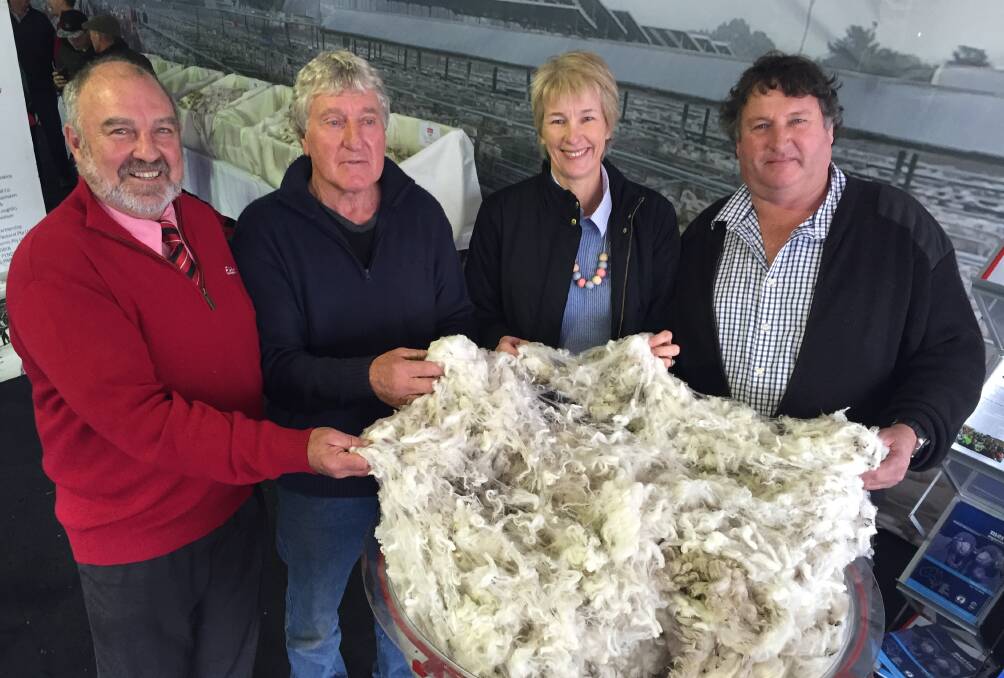 Supreme fleece: Elders' Malcolm Nichols, sheep classer Denis Crawford with winners Jenny and Allan Johnson, Echo Cottage, Tasmania.