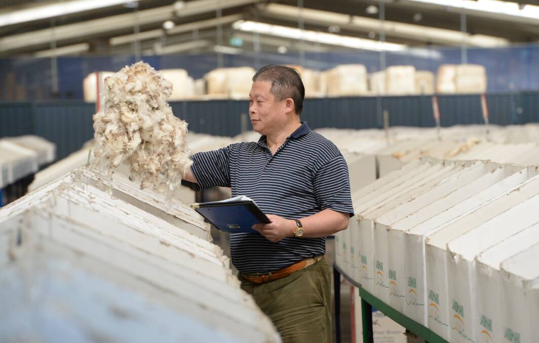 Victoria Wool Processor, Sydney Manager, Harry Ying inspecting fleece at the Sydney auctions recently. Photo Rachel Webb. 