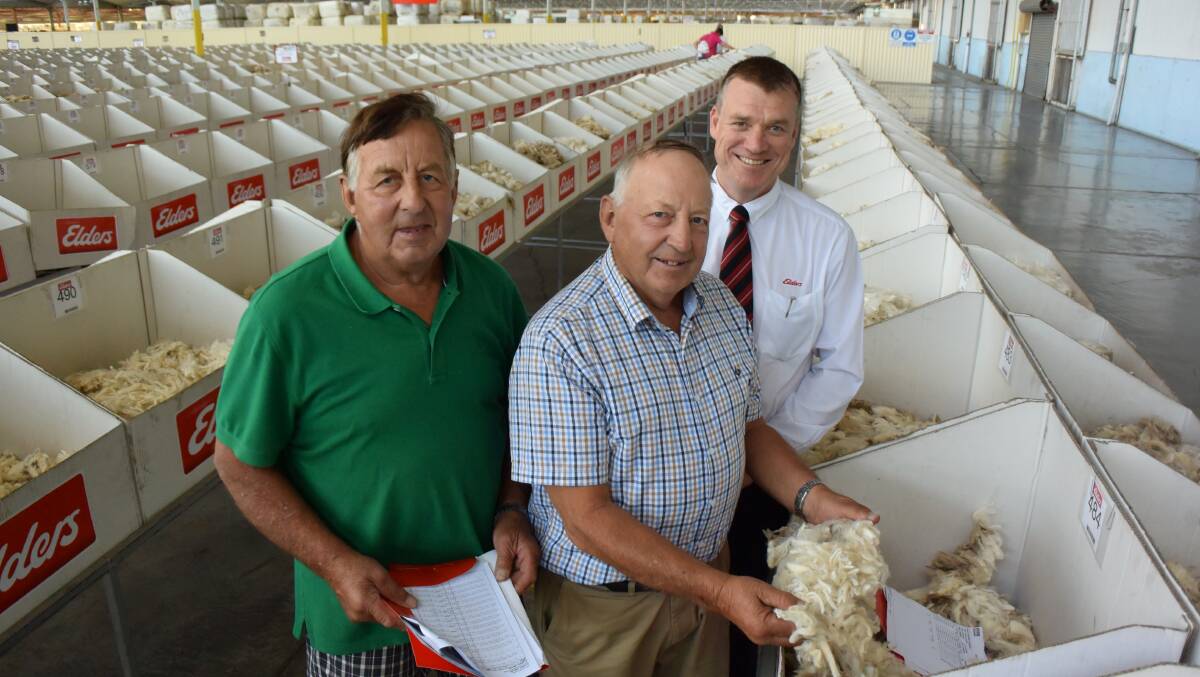 Barrie and Ivor Ubergang, Hamilton, with Elders wool broker Andrew Howells, sold 136 bales of 16.5-18m at Melbourne wool auction on Thursday. 
