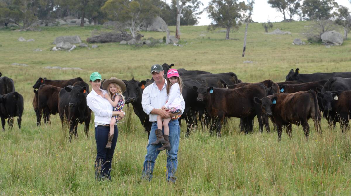 Erica and Sam Ulrick, and their daughters, Harriet, 4, and Emily, 7, with Angus breeders at "Obanview", Guyra, NSW. 