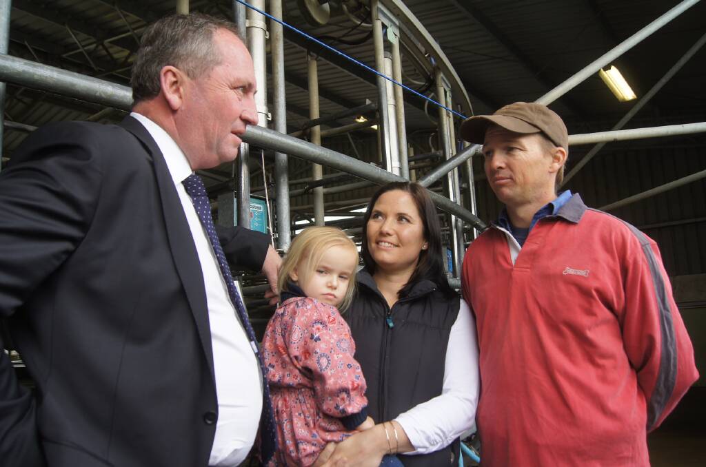 Nationals leader Barnaby Joyce with Ashley Galt, wife Lucy and baby Alice on their dairy farm near Shepparton in Victoria during talks to refine the government's support package last month.