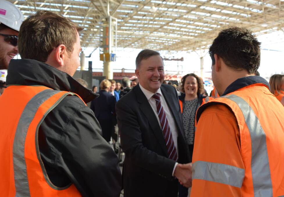Shadow Infrastructure and Transport Minister Anthony Albanese - greeting workers at a rail project opening - believes the government's go slow on the inland rail project is not good enough.