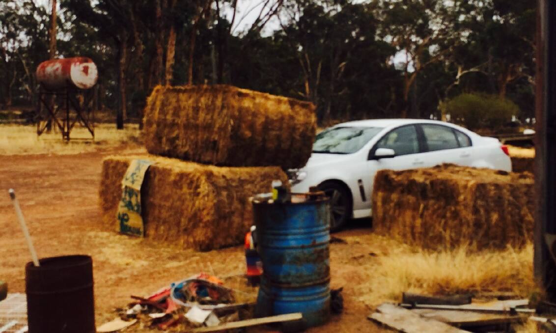 The receivers' car blocked in by bales on Bruce Dixon's Cuballing farm that One Nation WA Senate candidate Rod Culleton claims were made of straw - not hay - but may well block his passage to federal parliament.