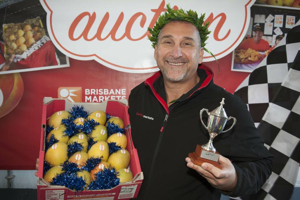 BIG SPENDER: The 2016 Queensland Mango King, George Manettas, Earth Markets Burleigh, with his $22,000 tray of mangoes which he purchased this morning.