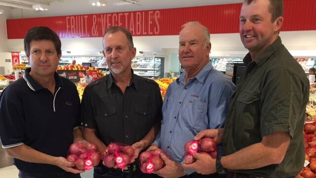 NO TEARS: Mannum region onion growers Malcolm McKerlie, Steve Rathjen and Phil and Aaron Haby show off the latest variety from Rivapak.