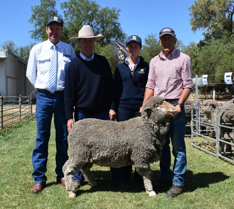 Purchaser of the top price ram at Hazeldean Hay Ram sale Adam Mort, "Tallawanga", Mudgee, holds ram while auctioneer Paul Dooley, Tamworth; and Hazeldean's Jim and Bea Litchfield look over him.