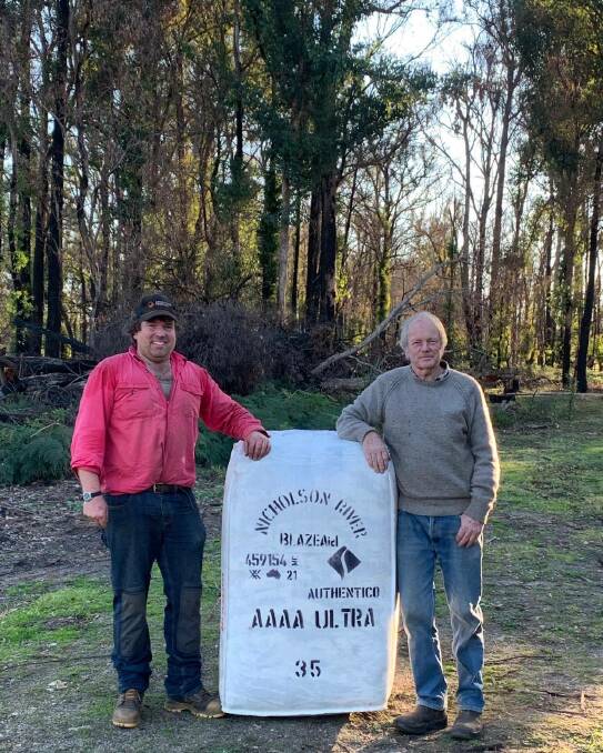 SON AND FATHER: Hugh and Doug Pemberton, Nicholson River Merino stud, Sarsfield/Nicholson, donated $1897 to BlazeAid from the sale of this bale of wool after the organisation helped repair kilometres of burnt fencing.