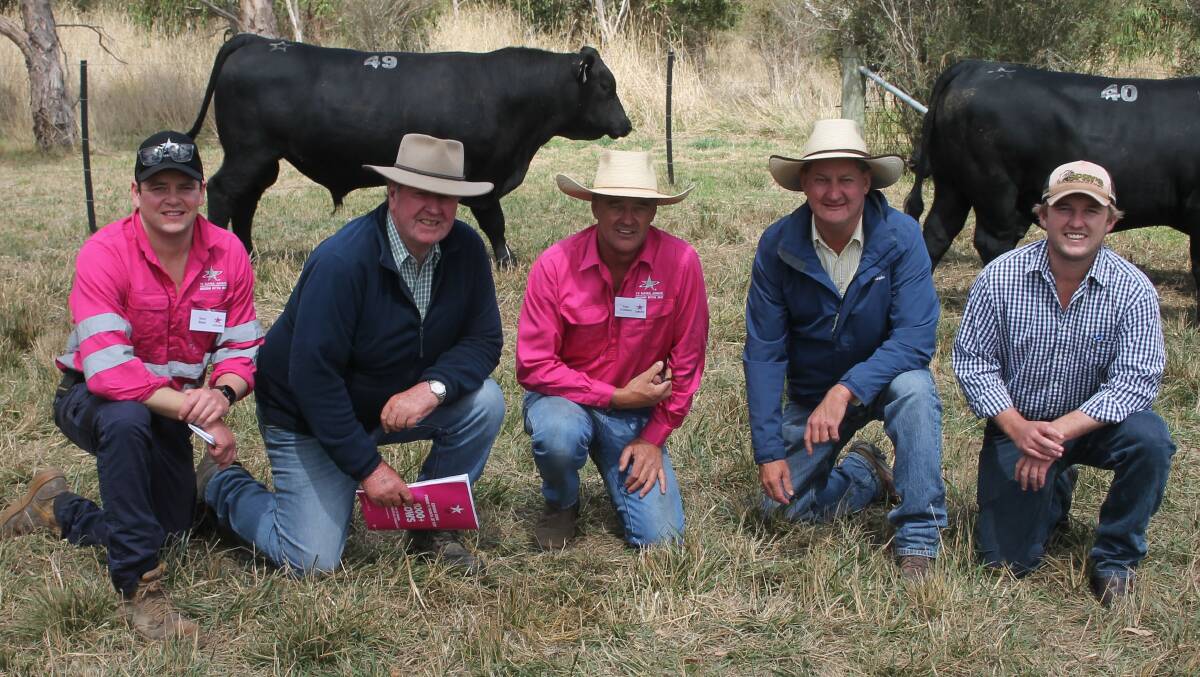 Te Mania farm manager Sam Reid, Mortlake, Independent Breeding & Marketing Service director Dick Whale, Te Mania co-director Tom Gubbins, Mortlake, Geoff Hayes, Ray White Rural Glen Innes, NSW, and Ryan Schmitt, Buringal Grazing, Nundle, NSW with top-priced bull Lot 49, Saville S258, which fetched $110,000. Picture by Philippe Perez