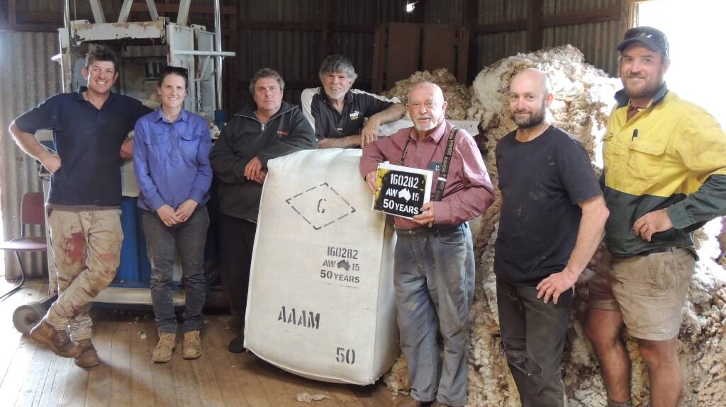 STILL HAS IT: Mr Noonan pictured in the Diamond G shearing shed at Carwarp. Wool grower Marc Bowen (far left) says Mr Noonan started classing in the shed for his late grandfather in the 1970s.