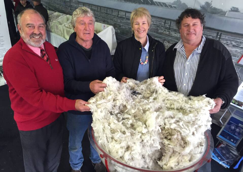 Elders' Malcolm Nicholls, sheep classer Denis Crawford with winners Jenny and Allan Johnson, Echo Cottage, Tasmania.