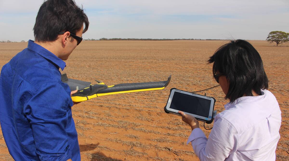 HOW IT WORKS: Yin Lee from UPG demonstrates the Sensefly eBee UAV with BCG precision ag specialist Sebastian Ie.