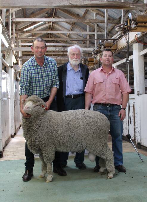 Melrose stud principal Warren Russell holding the top priced ram, Lot 13.
