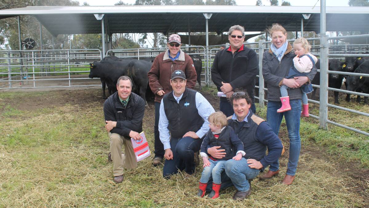 Landmark's Richard Miller, Stoney Points Peter Colliver with the equal top price buyers Mark & Renee Egel, Keith SA (back) and Susan holding Lucinda and Hugh with Hamish Russell (front-right) from Dunneworthy Pastoral, Ararat. 