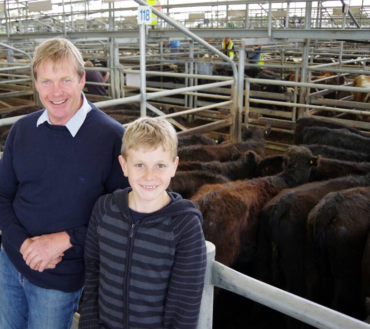Black Mountain Station principals Chris and Hugh (11) Nixon with their two pens of 12mo Angus heifers, sold at $1000 at Bairnsdale on Friday.