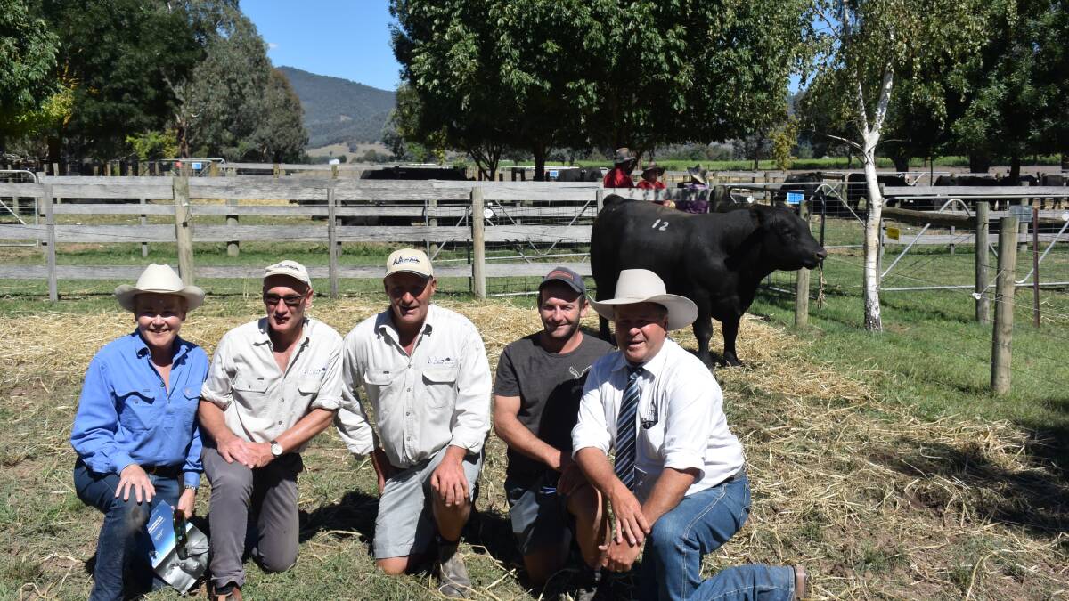 Suzy Martin, Jim Delany, Chris Oswin, with Jake Faithfull, Corryong, equal top-price buyer, and auctioneer Michael Glasser GTSM.