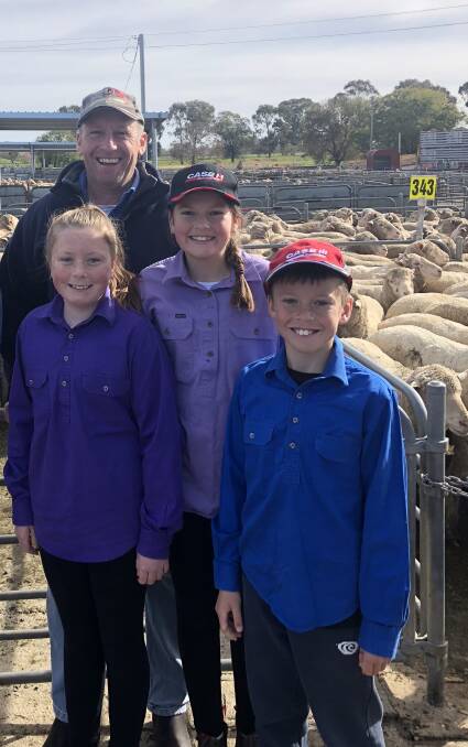 FAMILY VENDOR: Mark Duffy, pictured with his children, sold crossbred ewes with Rodwells for $215 a head at the sheep sale at Corowa, NSW.