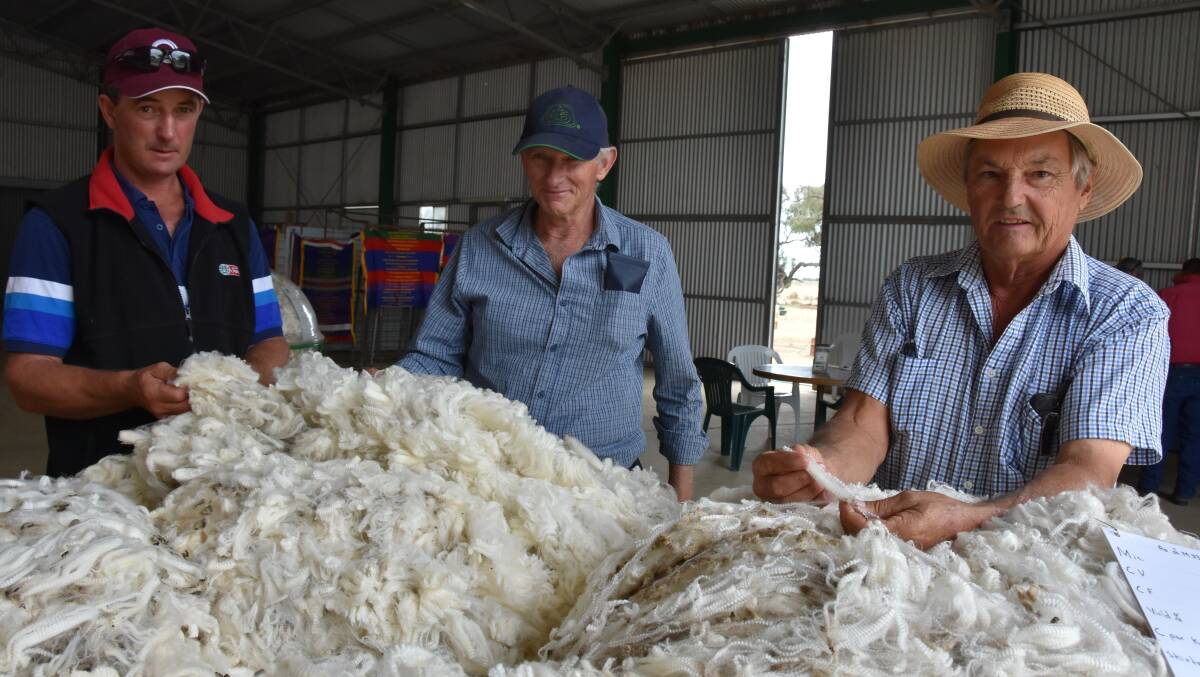 WOOL ON DISPLAY: Mal Isaac and Peter Colvin, Powlett Plains, checked out some of Kedleston Park Merino and Poll Merino stud's wool, with principal John Humbert, at the recent Loddon Valley Field Day.