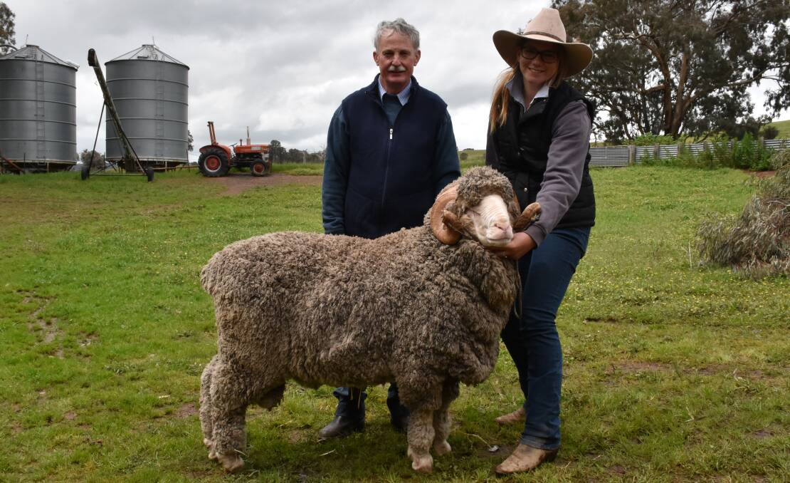 TOP-PRICED RAM: Kilfeera Park stud principal Murray McKenzie, and top-priced buyer Rose Nevinson, Cobb Run, Booroorban, NSW, with the top-priced ram, which was snapped up at $2100. Photo: Joely Mitchell.