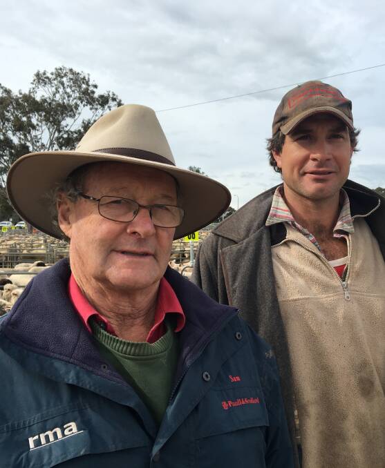 GOOD DAY: Paull & Scollard's Sam McCulloch with Culcairn producer Clint Dunn, who sold 80 new season lambs for $130 at Corowa on Monday.