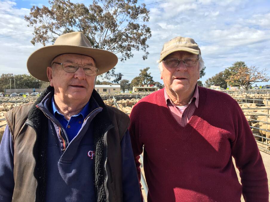SALE: Harvey Benton from Corcoran Parker, Wangaratta with Springhurst producer Rex Benton, who sold 22 new season lambs for $146.20 at Corowa on Monday.