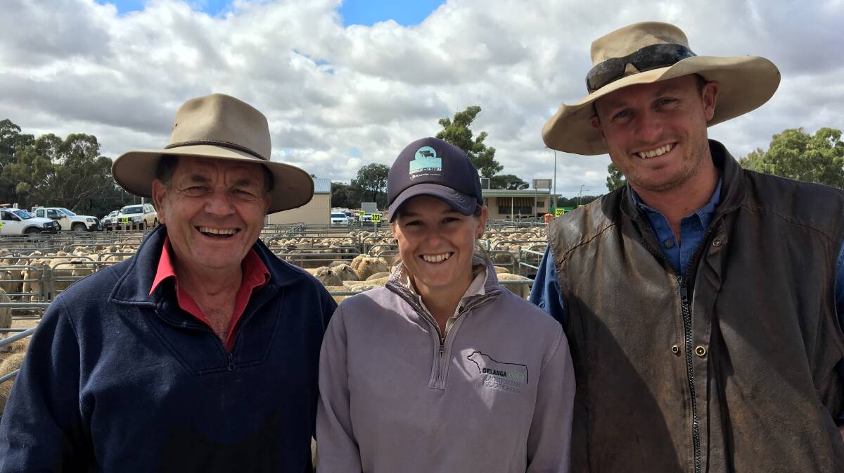 SOLD: Steve Paull from Paull & Scollard with Corowa producers Kate and Murk Schoen, who sold 157 shorn lambs to $174.20 at Corowa. Lamb numbers were up in a very good yarding, with the best lambs finished on lucerne. 