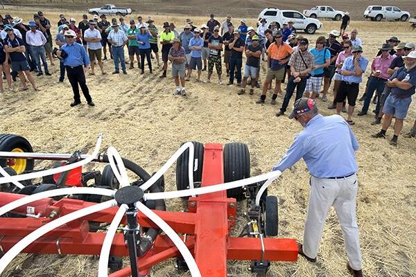 A representative from O'Connors Machinery explains the ins and outs of the Bourgault bar.